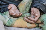 Homeless woman holding hands out help