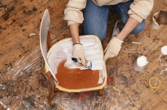 Top view woman restoring wooden furniture
