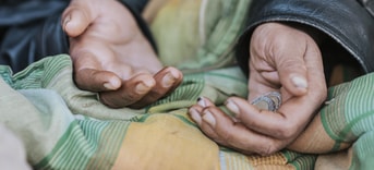 Homeless woman holding hands out help