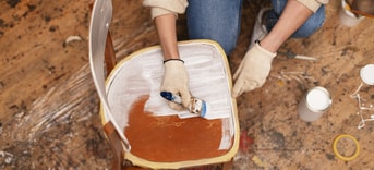 Top view woman restoring wooden furniture