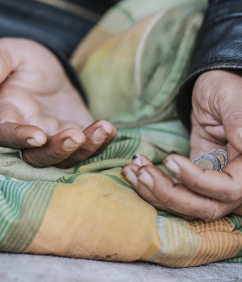 Homeless woman holding hands out help